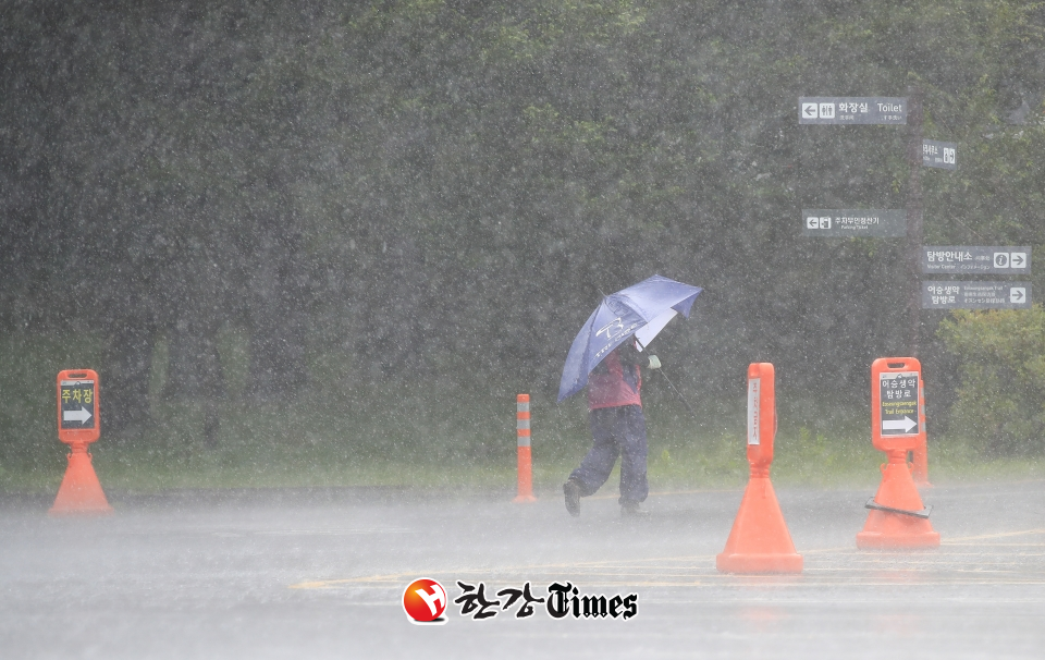 제주도 산지에 호우주의보가 내려진 지난 27일 오전 제주 한라산 어리목 탐방로 입구에서 우산을 쓴 시민이 장대비를 피해 이동하고 있다. (사진=뉴시스)